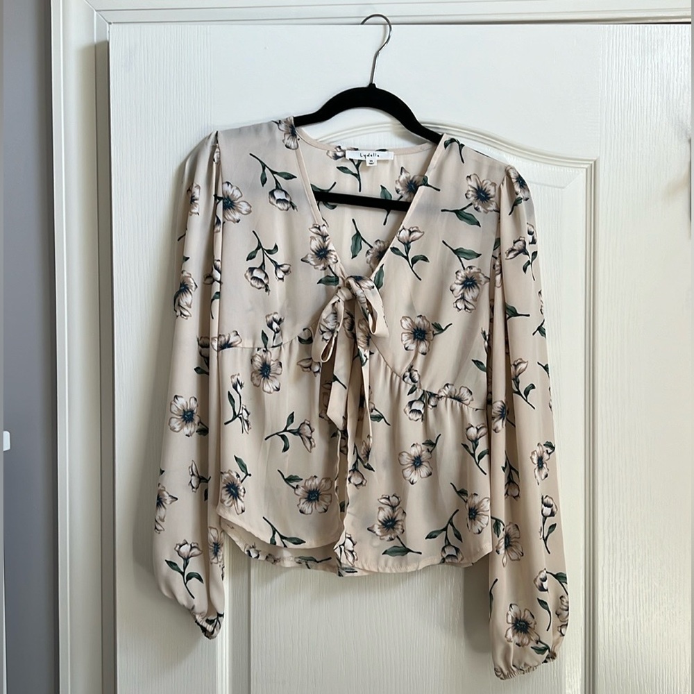Floral tie front blouse with long sleeves from a boutique.